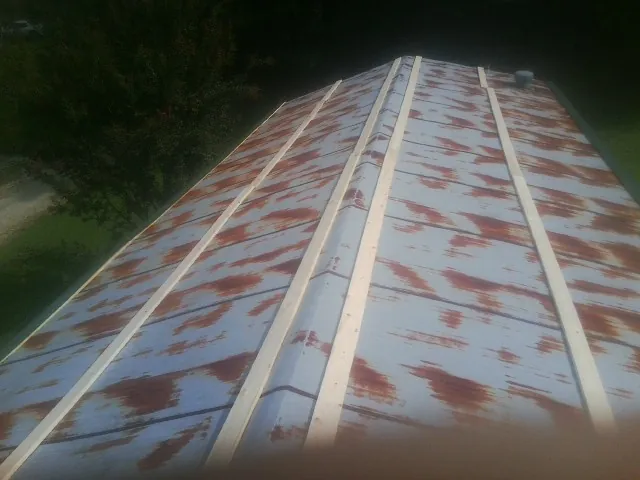 Rusted metal roof panels with new wood purlins before replacement — Storm Damage Roof Repair in Yamhill by Roofing Brothers