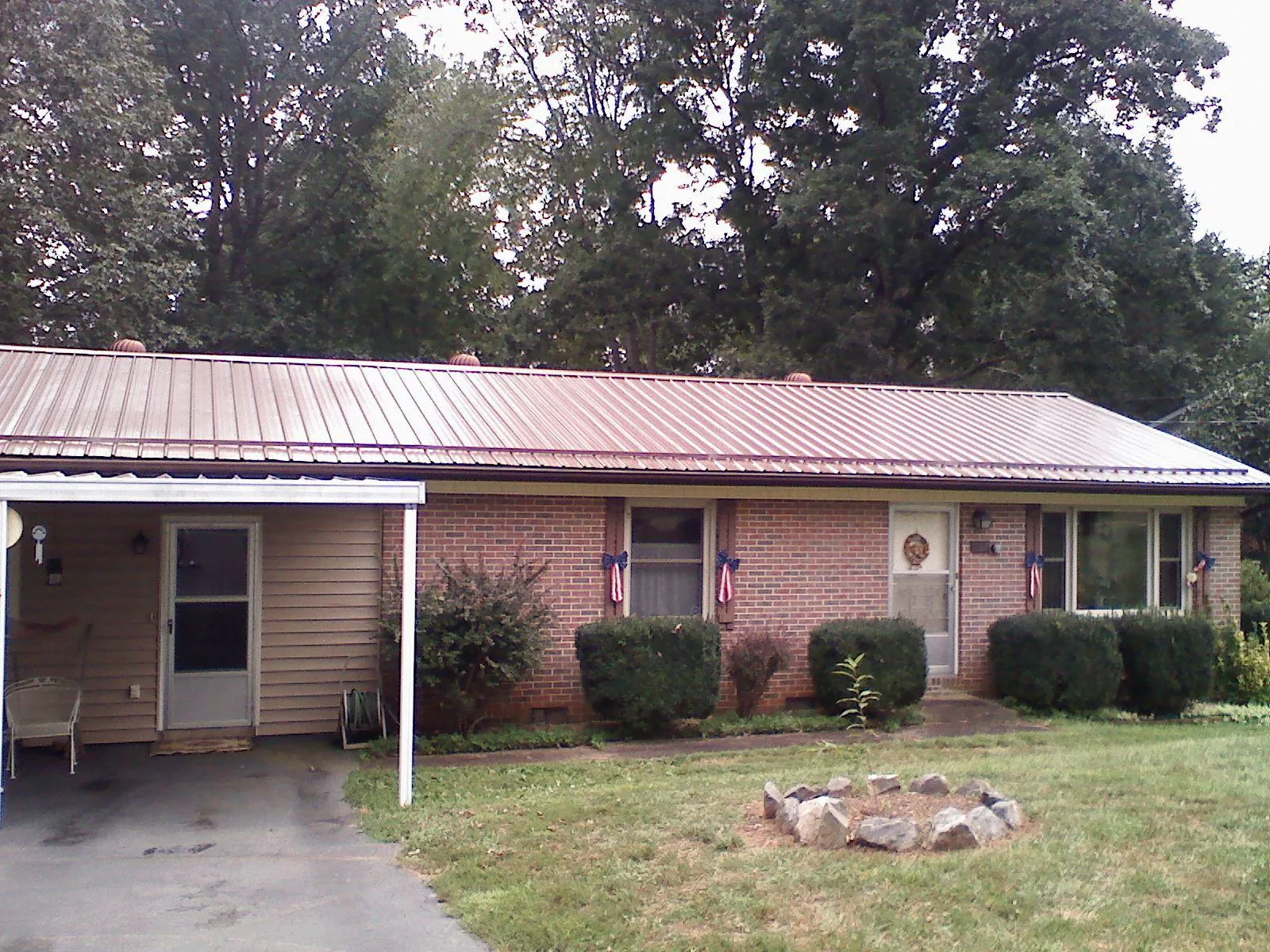 Bronze metal roof and carport on a brick ranch home — Roof Repair work by our crew in Yamhill